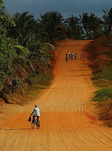 a person riding a bike down a dirt road