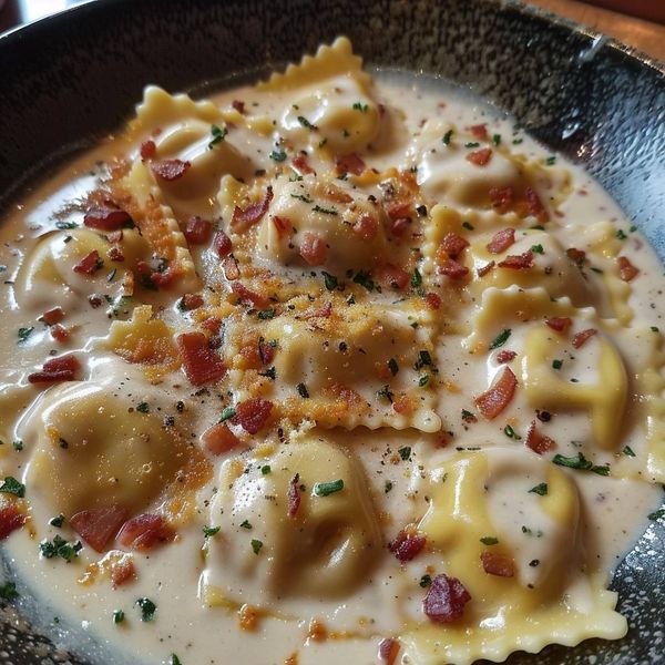 a black bowl filled with pasta and cheese