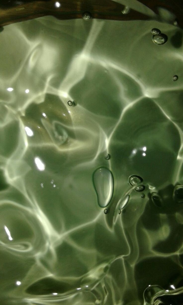 the water is green and has bubbles in it