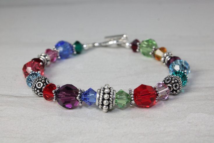 This custom sterling silver and multi color swarovski crystal bracelet makes a beautiful keepsake gift. Shipped in a lovely gift box ready for gifting. Perfect keepsake that will be cherished forever. Sterling Silver Crystal Bracelet With Birthstone As Gift, Personalized Silver Crystal Bracelet For Gift, Personalized Silver Crystal Bracelet For Anniversary, Hypoallergenic Sterling Silver Crystal Bracelet Gift, Nickel-free Crystal Bracelet With Round Beads As Gift, Silver Beaded Birthstone Bracelet As Gift, Silver Crystal Bracelet For Birthday And Mother's Day, Elegant Rainbow Bracelets For Gift, Elegant Rainbow Bracelets For Gifts