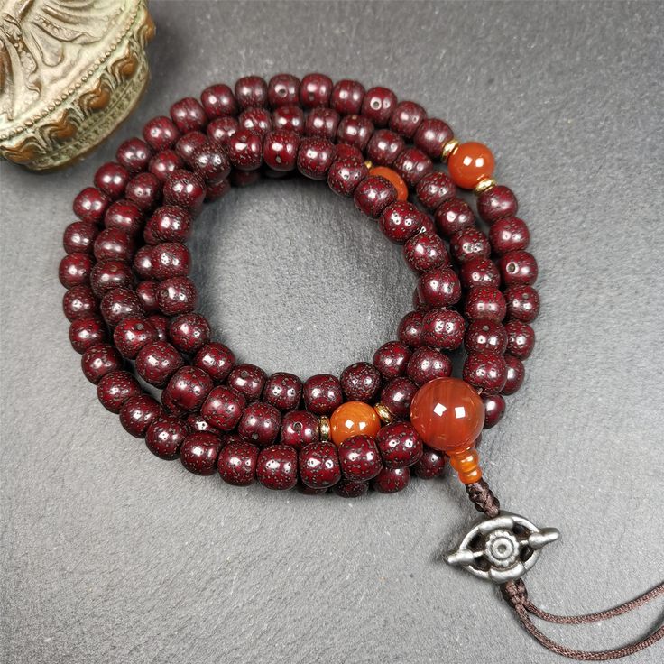 This mala is made by Tibetan craftsmen and come from Hepo Town, Baiyu County,Tibet, the birthplace of the famous Tibetan handicrafts. It's composed of 108 pcs 9mm lotus seed beads,with agate spacer beads,and agate bead counters,diameter 0.35 inch,circumference 35 inches. Red Round Beads Mala For Meditation, Red Mala For Meditation With Round Beads, Red Mala With Round Beads For Meditation, Red 8mm Beads Spiritual Mala, Adjustable Artisan Mala For Rituals, Adjustable Mala With 108 Beads For Rituals, Round Beaded Bracelets For Meditation And Festivals, Beaded Bracelets With Round Beads For Meditation And Festivals, Red Mala With 108 Beads For Puja