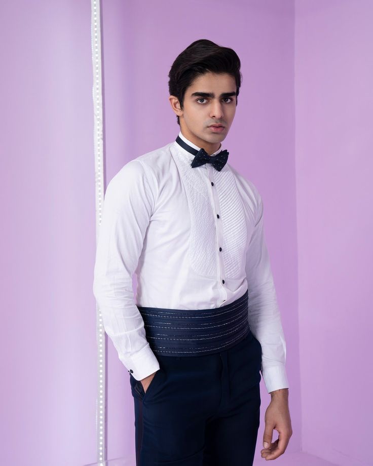 Cosmic Tuxedo Set - Contrast by Parth This tuxedo set features a shrug-style design, offering an optional front button closure, intricate embroidery adorning the front, and a distinctive geometric lapel. Included in purchase: Tuxedo, Shirt, Pants, Bowtie and Sash Product Specification Color: Black (can be customized) Fabric: Italian Suiting Occasion: Formal Event, Wedding, Bridal, Reception Style: Tuxedo Designer: Contrast by Parth Care: Dry Clean Only Work: Hand Embroidered ( Variation in color Elegant Slim Fit Long Sleeve Sets, Elegant Long-sleeved Slim Fit Sets, Elegant Long Sleeve Slim Fit Set, Fitted Long Sleeve Sets For Semi-formal Occasions, Fitted Tuxedo Set With Long Sleeves, Tailored Long Sleeve Party Sets, White Long Sleeve Tuxedo For Party, Elegant Fitted Bandhgala For Tailoring, Elegant Party Sets With Suit Collar