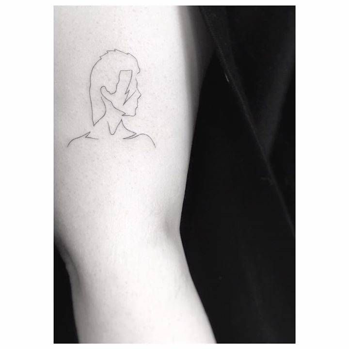 a woman's arm with a small tattoo on the left side of her arm