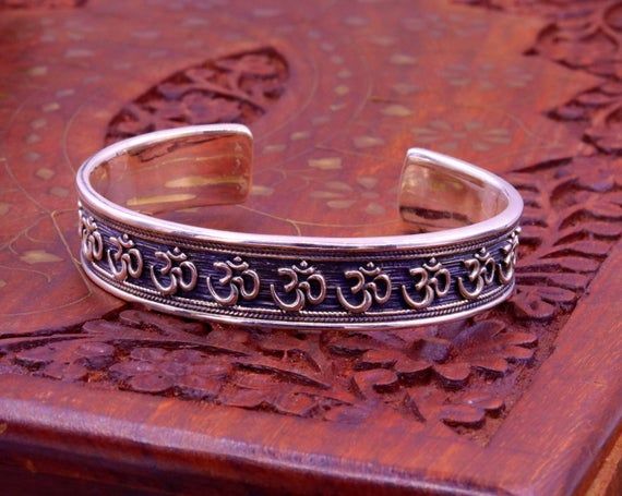 Excellent handmade 925 sterling silver Hindu mantra Aum bracelet, vintage antique stylish unisex gifting oxidized jewelry from Rajasthan india.Metal-925 sterling silver.Type-Bracelet/ kada.Size-Adjustable.Width-1.4 centimeters.Weight-42.470 grams approx.Finish-Oxidized.Stamped-925.Makes excellent gifting for birthday, wedding anniversary, mother's day, father's day Adjustable Metal Temple Jewelry Bracelet, Adjustable Antique Silver Hallmarked Bracelets, Adjustable Antique Silver Hallmarked Bracelet, Silver Brass Spiritual Bracelets, Spiritual Silver Brass Bracelets, Adjustable Spiritual Sterling Silver Bracelet For Weddings, Adjustable Cuff Bracelet For Ceremonial Festivals, Silver Spiritual Brass Bangle, Handmade Adjustable Sterling Silver Bracelet For Ceremonial Occasions