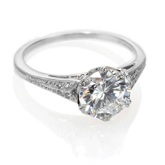 a white gold ring with an oval cut diamond in the center and pave set shoulders