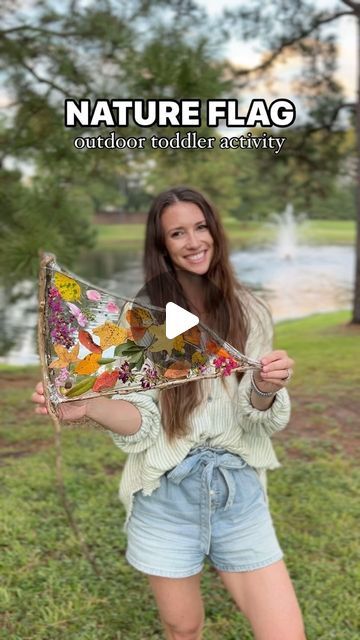 a woman holding up a colorful kite in her hands with the caption nature flag outdoors reddiet activity