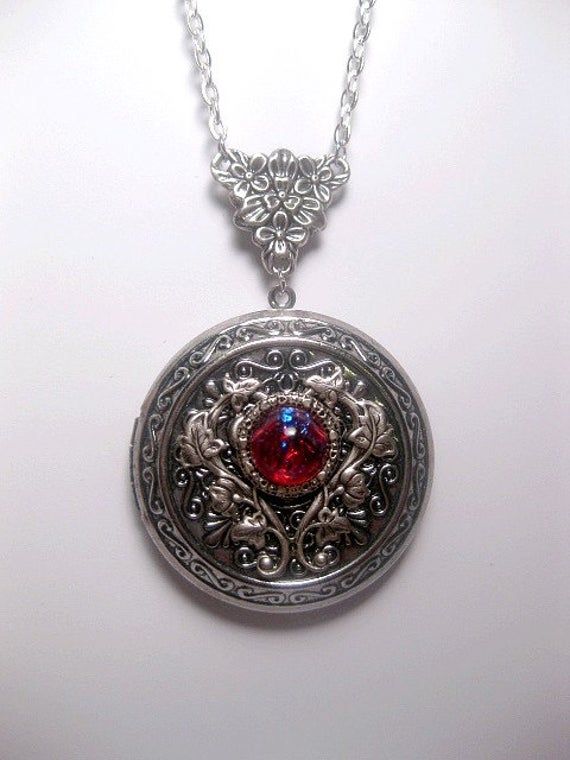 "Large Dragons Breath Locket Necklace This Large decoratively styled locket features the dragons breath faux opal. ☻Locket ~ Measures 1.77 inches round ☻The Small Opal ~ Generic (man-made, glass) Chain: Silver Plated YOU CHOOSE YOUR CHAIN LENGTH - Choose your chain length from \"drop down Menu\" tool ~ We take pride in the jewelry we make. ~ We offer a variety of items from fun casual, to quality, to higher quality ☻More DRAGONS BREATH JEWELRY: https://www.etsy.com/shop/FashionCrashJewelry/searc Fantasy Engraved Jewelry For Fantasy Events, Metal Jewelry With Dragon Design As Gift, Metal Jewelry With Dragon Design For Gift, Dragon Design Jewelry For Gift, Metal Dragon Design Jewelry Gift, Dragon Design Jewelry Gift, Round Dragon Design Jewelry For Gifts, Silver Dragon Design Jewelry For Fantasy Events, Silver Gothic Locket Jewelry