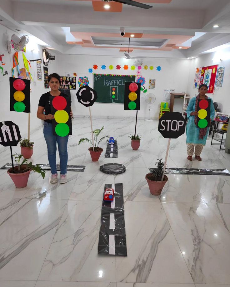 two people holding up stop signs in front of a room filled with potted plants