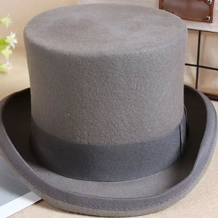 Welcome to our standalone platform, where timeless elegance meets sophistication - the Top Hat. Whether for formal occasions or personal style statements, this classic high-crowned hat is your ultimate choice. Ensure to order your regular hat size, as these hats fit true to size with more than enough room for comfort. Experience Elegance: Theater Quality Mens Top Hat Elevate your formalwear with our meticulously crafted mens top hat, designed for serious collectors and lovers of sophisticated style. Indulge in the theater-quality experience brought to you by the 100 percent wool felt body and smooth leather sweatband, making this top hat a must-have for those who appreciate the finer things in life. Timeless Tradition: Traditional Style Redefined Immerse yourself in the elegance of an earl