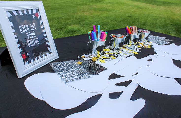 a table topped with paper cut outs next to a computer keyboard and framed photo on top of it