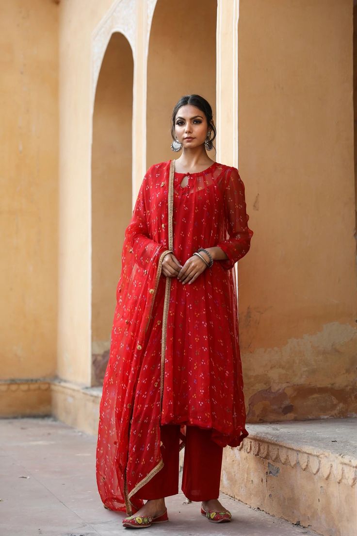 The set consists of georgette a line kurta comes with full length inner, hand work detailing round neck, calf length teamed with cotton palazzo pants and a georgette dupatta to match.The entire set has hand work detailing. Kurta Fabric-Georgette Pant Fabric-Cotton Duptta Fabric-Georgette Color-Red Kurta Length-45 inches Pant Length-37 inches Work-Hand Work Detailing & Bandhej Print Neck-Round Sleeves-Full Sleeves Washing Instructions-Dry Clean Model is 5'6 wearing small size. Festive Georgette Kurta For Transitional Season, Transitional Georgette Palazzo Set With Sheer Dupatta, Transitional Festive Georgette Kurta, Diwali Georgette Palazzo Set Floor-length, Festive Georgette Kurta With Sheer Dupatta, Diwali Floor-length Georgette Palazzo Set, Long Georgette Anarkali Set For Diwali, Festive Georgette Lawn Suit With Cutdana, Unstitched Long Palazzo Set For Navratri