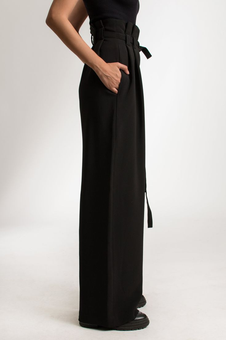 The Amorusso Pants are a high-rise, wide leg trousers, crafted from a cotton blend. The pants offer a flattering fit around the waist and hips. They come with a long detachable waist belt. These sustainable pants are tailor made and on demand. It takes us 6 hours to make these pants. PLEASE ALLOW 1-3 BUSINESS DAYS FOR PRODUCTION Black High-waist Bottoms With Belt Detail, Black High Waist Bottoms With Belt Detail, High Waist Black Bottoms With Belt Detail, Black Belted Wide Leg Bottoms, Black Wide-leg Bottoms With Belt, Black Wide Leg Bottoms With Belt, Black Straight Leg Pants With Belt, Workwear Wide Leg Pants With Tie Waist, Chic Belted High-waisted Wide Leg Pants