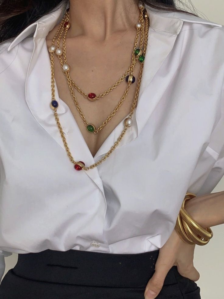 This vintage-inspired multi-layered necklace adds a touch of elegance and sophistication to any outfit. The combination of bold red, green, and blue gemstones, along with delicate pearls, creates a stunning contrast that enhances both formal and casual attire. With a versatile design, this necklace can also double as a statement waist chain, adding a unique flair to your style. The 1.8-meter length allows for various wearing options, making it a must-have for any jewelry collection. Details Material: Synthetic pearls, copper alloy with gold plating, colorful gemstones Color: Gold with red, green, and blue accents Style: Vintage-inspired multi-layered necklace Length: 1.8 meters (adjustable) Elegant Multicolor Jeweled Necklaces, Elegant Multicolor Necklaces For Formal Occasions, Elegant Multicolor Long Necklace, Elegant Red Chain Necklace For Party, Red Pearl Chain Necklace For Party, Elegant Multicolor Jewelry With Chain, Elegant Multicolor Multi-strand Jewelry, Elegant Multicolor Multi-strand Necklace, Multicolor Pearl Necklace For Parties