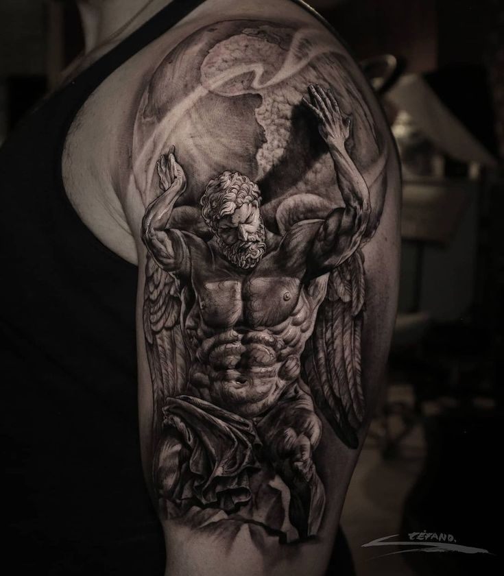 a man's arm with an angel and demon tattoo on the upper half of his arm