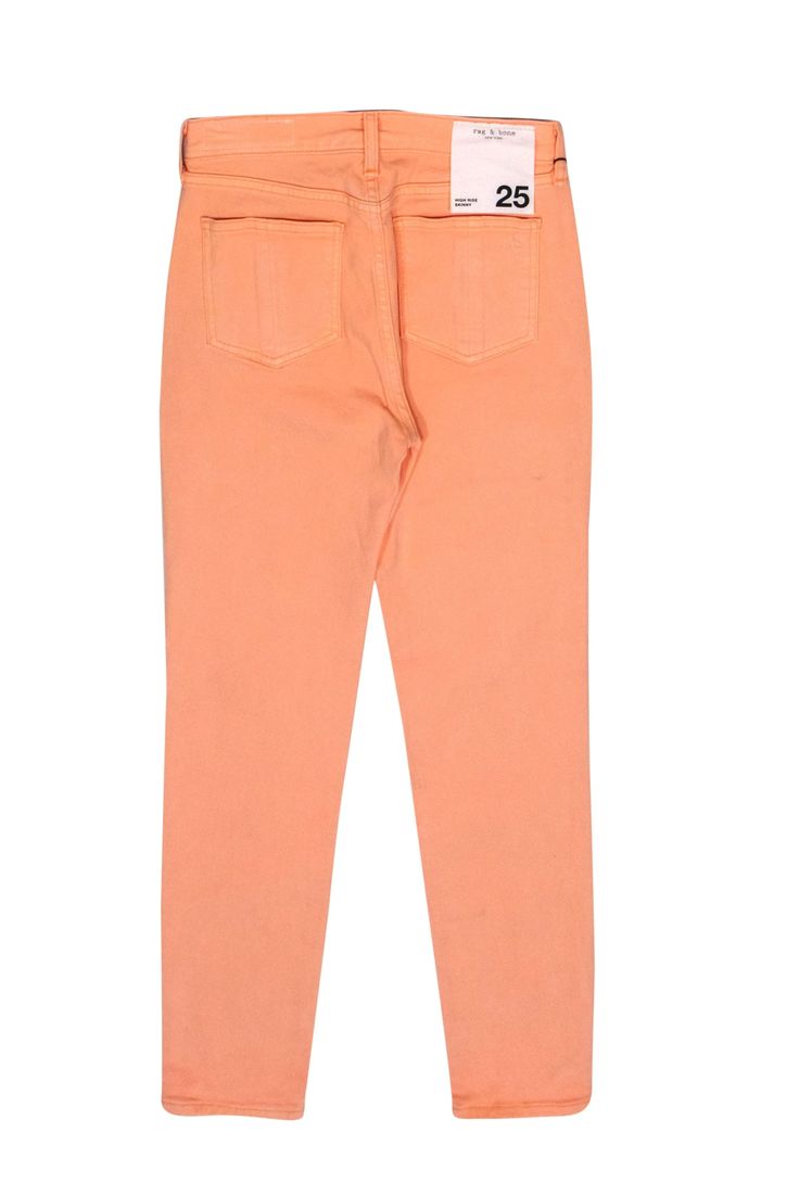 Get some peachy keen jeans with these high rise skinnies from Rag & Bone! Made with a slim design in a sunny orangey-pink, these are a vibrant statement jean to wear with white tees in the summer or dark sweaters for some bright vibes in the winter. Size 25 98% Cotton, 2% Elastane High rise fit with button and zipper closures Five pocket construction Skinny leg Waist 28" Total length 37" Orange Jeans For Spring, Spring Orange Jeans With Pockets, Casual High Waist Peach Bottoms, Casual Peach Pants For Spring, Orange Straight Leg Jeans For Spring, Trendy Orange Straight-leg Pants, Casual Orange Summer Jeans, Trendy High Rise Orange Bottoms, Trendy Orange Straight Leg Pants