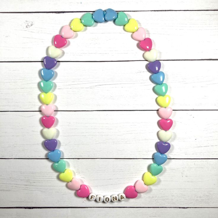 "You have just found the perfect gift for birthdays or Easter! This cute pastel, retro HEART necklace can come personalized or with hearts only. This 16\" stretchy necklace fits right over your head so it's easy to put on- no clasps needed. The matching bracelet is listed here: https://www.etsy.com/listing/909362079/kids-heart-bracelet-party-favor-girls?ref=shop_home_active_5&frs=1 Please check all selections and spelling prior to check out. Our custom jewelry is made to order so all sales a Personalized Playful White Necklace, Playful Personalized White Necklace, White Heart Necklace For Birthday And Valentine's Day, Cute Personalized Heart Necklace For Mother's Day, Fun Pink Necklace For Birthday, Cute Personalized Multicolor Necklaces, White Heart Charm Necklace For Birthday, Cute Multicolor Necklace For Birthday, Cute Multicolor Personalized Necklaces