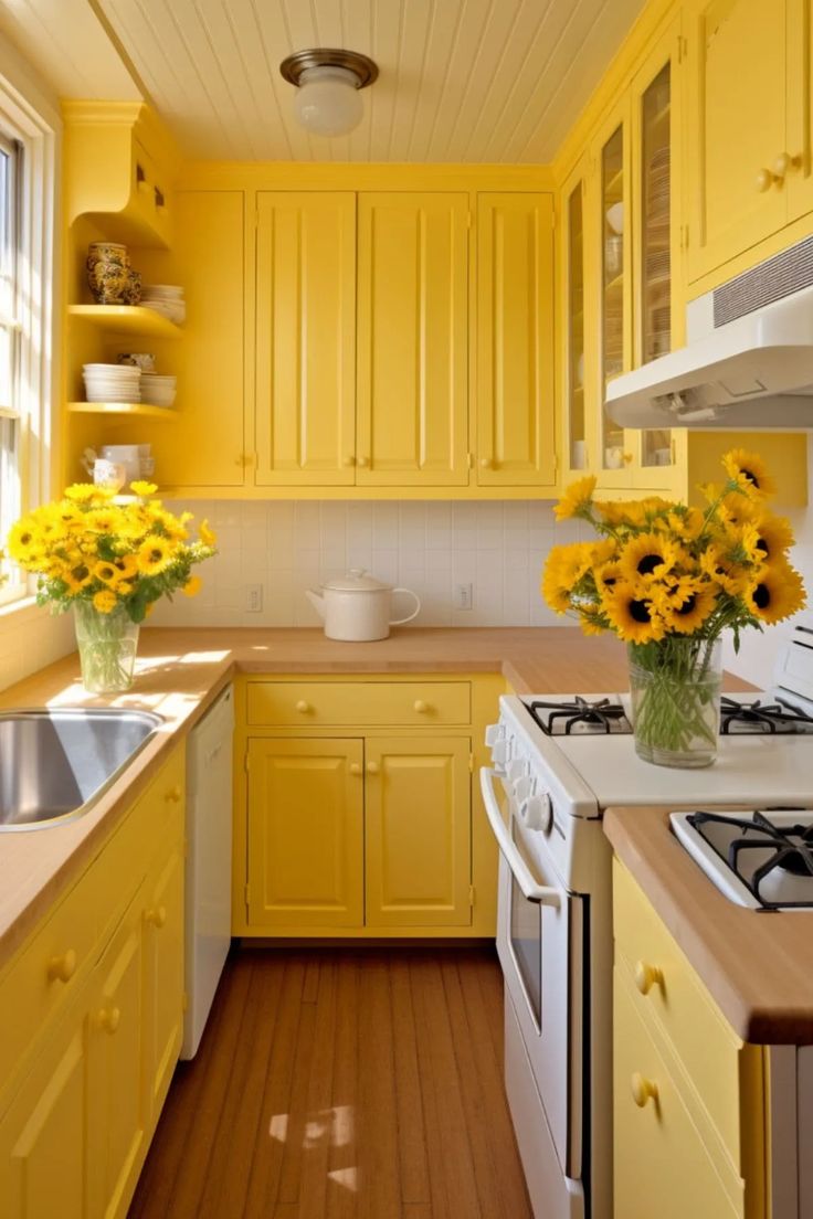 a yellow kitchen with sunflowers in vases on the stove top and sink