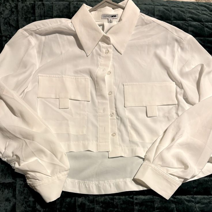 White Crop Long Sleeve Button Down Blouse Fashion Nova Size Small Tags Removed Never Worn Chic Button-up Cropped Shirt With Button Closure, Chic Cropped Button-up Shirt With Pockets, Chic Button-up Cropped Shirt With Pockets, White Long Sleeve Cropped Shirt With Button Closure, Elegant White Button-up Cropped Shirt, Chic Collared Tops With Button Cuffs, Chic Cropped Office Shirt, Button-up Cropped Shirt With Pockets For Work, Cropped Fall Blouse With Buttons