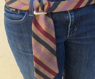 there is a woman wearing a striped tie on her waist and blue jeans with the belt undone