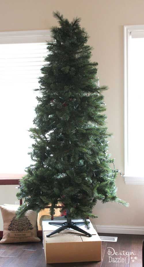 a small christmas tree in a box on the floor