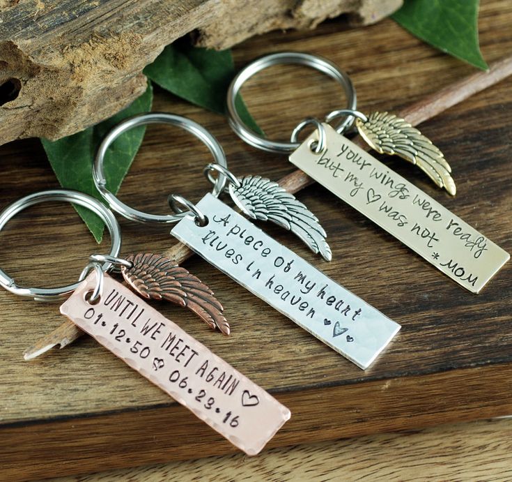 three keychains with two different names and one has an angel on the front