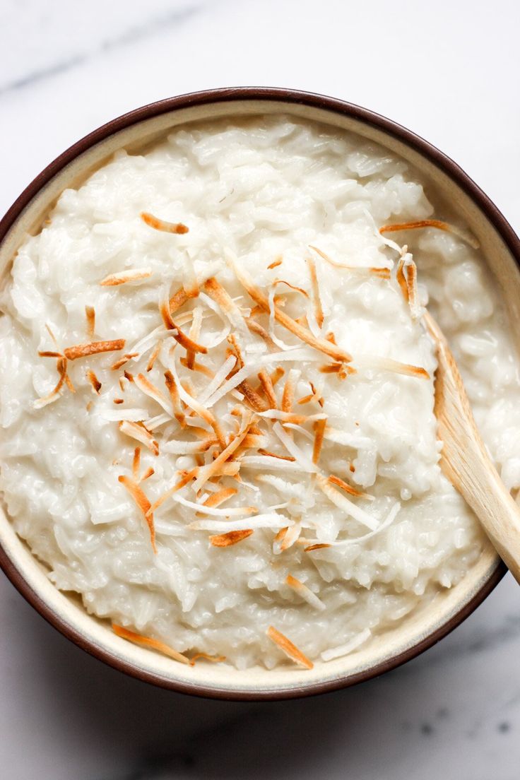 a bowl filled with rice and topped with shredded cheese