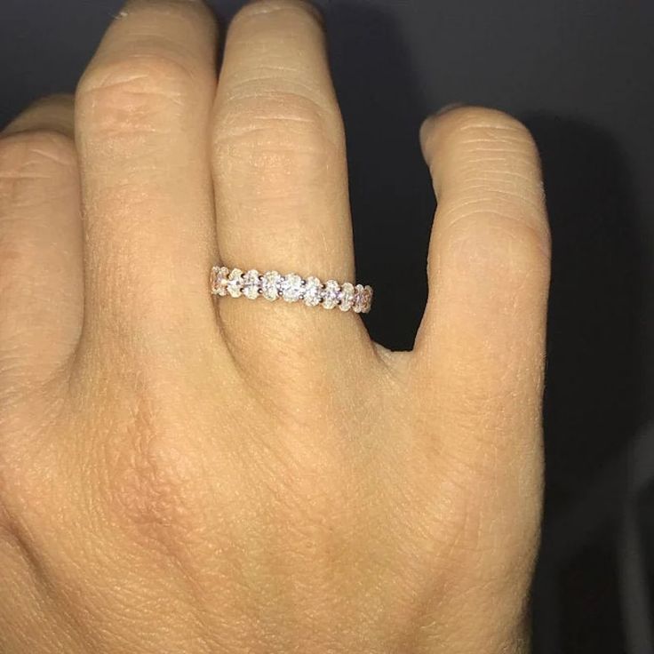 a woman's hand with a diamond ring on it