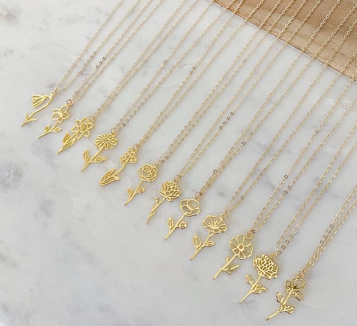 Beautiful hanging flower necklace on 14k gold filled chain with 14k gold filled jumprings and clasp. 14k gold plated pendant measuring approximately 9~13 X 25~27 mm (including the loop) depending on which flower. Giftbox included.January // SnowdropFebruary // VioletMarch // DaffodilApril // DaisyMay // Lilly of the ValleyJune // RoseJuly // Water LilyAugust // PoppySeptember // Morning GloryOctober // CosmosNovember // ChrysanthemumDecember // Holly Berry Gold Birth Flower Necklace, Birth Flowe Delicate Handmade Gold Charm Necklaces, Delicate Gold Jewelry With Rose Design, 14k Gold Filled Flower Necklace, 14k Gold-filled Flower Necklace, Minimalist Gold Birth Flower Necklace, Adjustable Gold Necklace With Birth Flower, Gold Charm Necklace With Flower Pendant And Lobster Clasp, Gold Flower-shaped Jewelry With Lobster Clasp, Minimalist Gold Flower Necklace