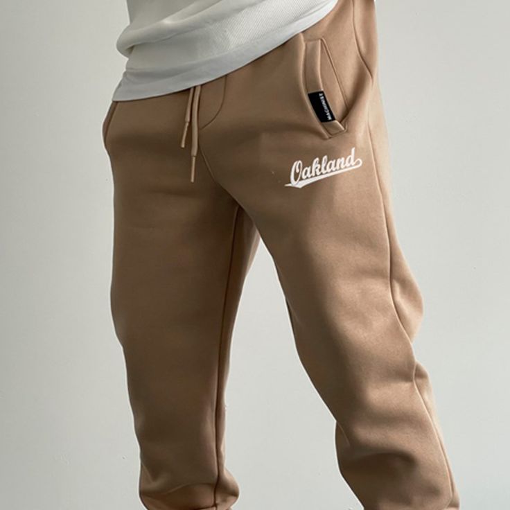 Oakland Fleece Sweatpants Leisure Fleece Bottoms With Letter Print, Fleece Joggers For Leisure, Winter Streetwear Beige Pants, Beige Winter Streetwear Pants, Winter Beige Streetwear Pants, Sporty Brown Sports Pants, Leisure Fleece Sweatpants With Letter Print, Casual Winter Jogging Pants, Brown Sweatpants For Winter Streetwear