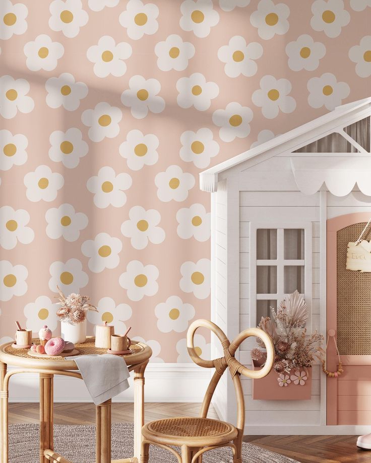 a doll house is set up in front of a wallpapered room with pink and white flowers