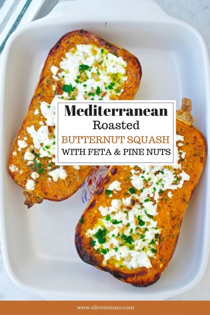 two pieces of bread with feta and pine nuts on top in a white plate