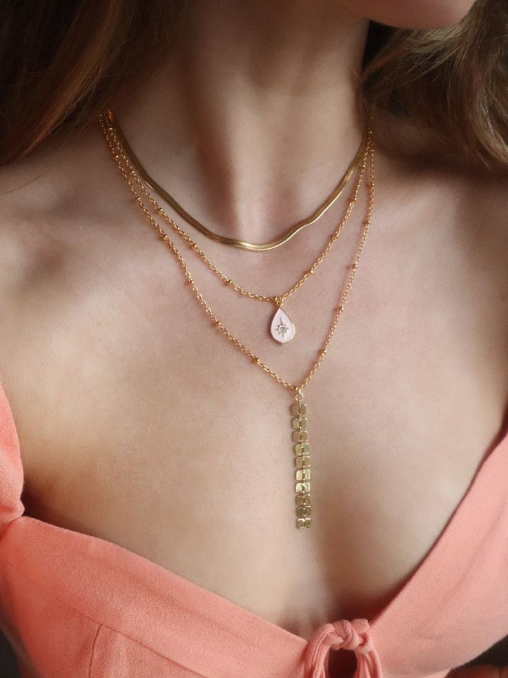 This golden necklace layer features three seperate necklaces, made to be worn beautifully together, or apart. 💓  First herringbone chain measures 16inches, second pink enamel pendant is 18 inches, and the final sparkle-long chain is 20 inches. Gold Snake Chain Layered Necklace For Gift, Gold Double Chain Herringbone Necklace Gift, Gold Herringbone Necklace With Double Chain As Gift, Gold Double Chain Layered Necklace As Gift, Gold Snake Chain Layered Necklace Gift, Gold Double Chain Charm Necklace For Gift, Layered Gold Plated Necklaces As Gift, Layered Gold Plated Necklaces For Gifts, Gold Double Strand 14k Gold Filled Layered Necklace