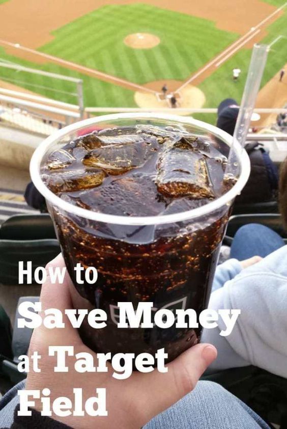 a person holding a drink in their hand with the words how to save money at target field