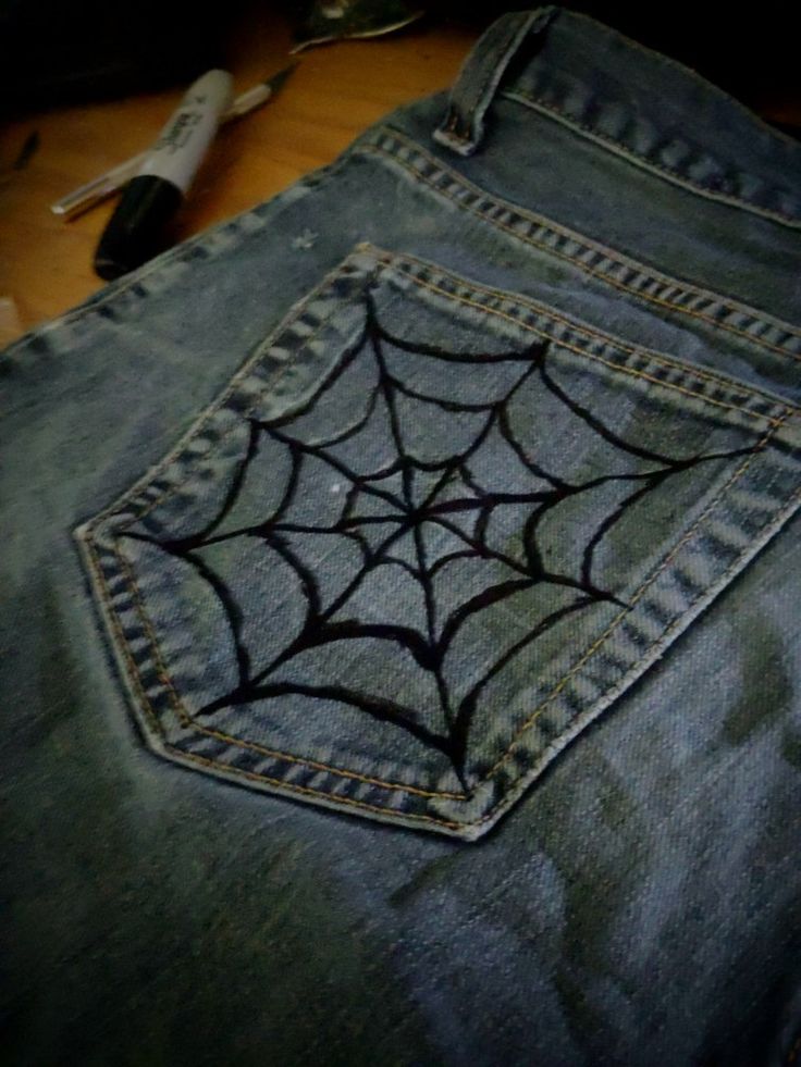 a pair of jeans with a spider web in the back pocket