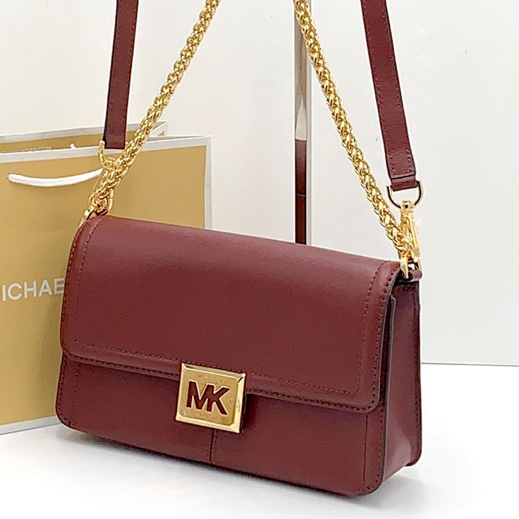 Michael Kors Sonia Medium East West Shoulder Crossbody Bag Merlot Color Color: Merlot Shoulder Bag Leather 100% Leather Gold-Tone Hardware 10.25”W X 5.75”H X 2.75”D Exterior Details: Back Slip Pocket Interior Details: Back Zip Pocket Lining: 100% Polyester Snap Fastening Michael Kors Mobile Phone Bag, Chic Michael Kors Shoulder Bag With Phone Pocket, Michael Kors Rectangular Shoulder Bag With Chain Strap, Michael Kors Shoulder Bag With Mobile Phone Bag, Michael Kors Purple Bags For Everyday Use, Michael Kors Purple Everyday Bags, Michael Kors Rectangular Shoulder Bag With Detachable Strap, Michael Kors Luxury Burgundy Bags, Luxury Michael Kors Burgundy Bags