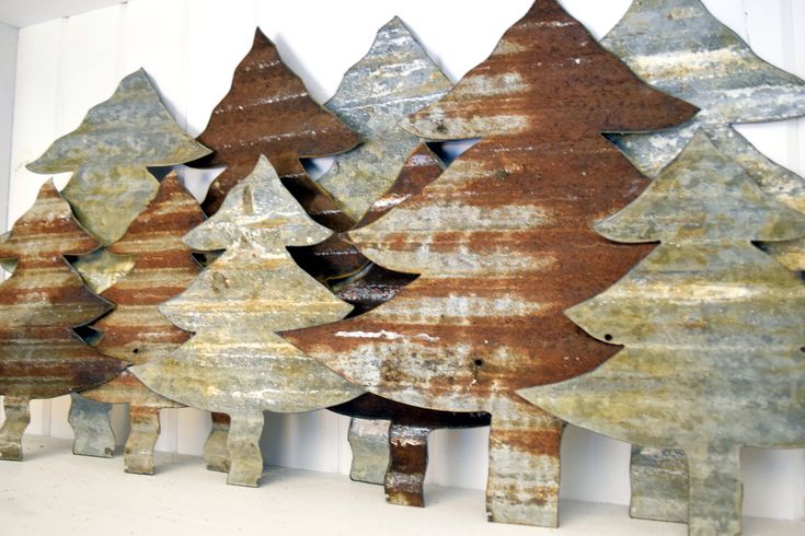 three metal christmas trees sitting next to each other