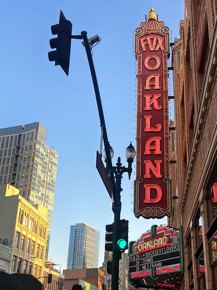 a street sign that is on the side of a building with buildings in the background