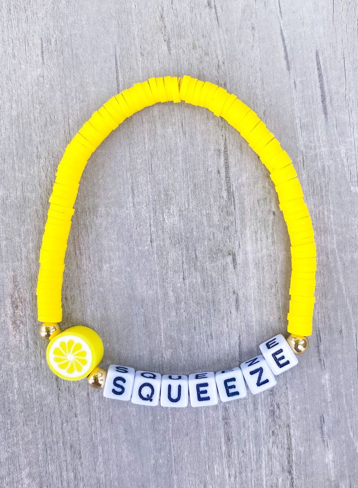 SQUEEZE Bracelet 🍋 The perfect bracelet for the lemon lover 🍋 Made with heishi yellow beads, 18k gold filled accents, 4mm square letters that read "SQUEEZE" and 1 lemon charm If you would like another word, please put in Personalization Section* CARING TIPS FOR YOUR JEWELRY ⭐️Treat and store with care. ⭐️ For longevity, avoid exposing your jewelry to water. ⭐️ Avoid having direct contact with lotions, perfumes, sanitizers as these chemicals may cause discoloration of your jewelry. Yellow Letter Beads Friendship Bracelets, Personalized Yellow Bracelets With Round Beads, Yellow Friendship Bracelets With Letter Beads, Personalized Yellow Stretch Bracelet As Gift, Yellow Beaded Stretch Bracelet For Friendship, Adjustable Yellow Novelty Jewelry, Yellow Letter Beads Friendship Bracelets As Gift, Adjustable Novelty Yellow Jewelry, Gift Yellow Letter Beads Friendship Bracelets