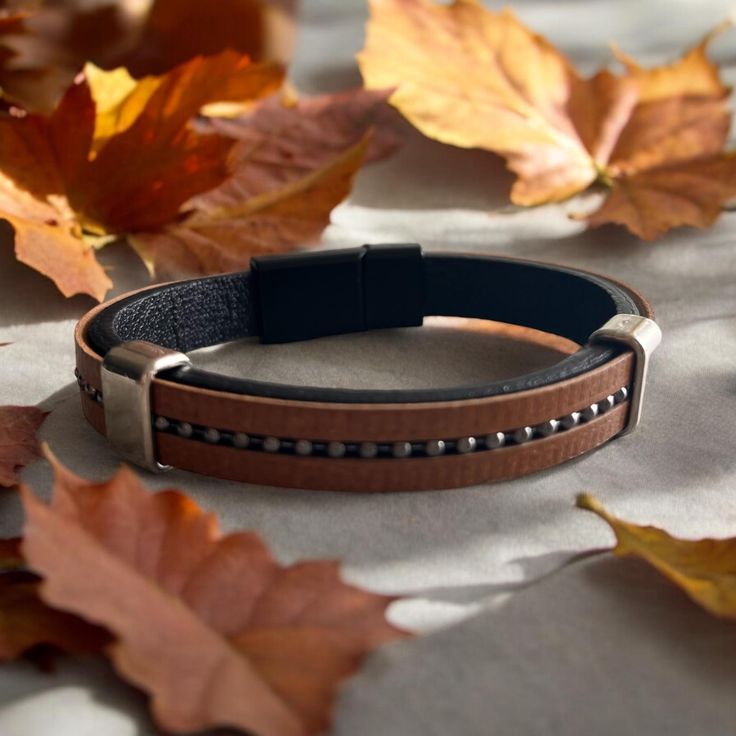 Elevate your style with this Men's Leather Bracelet featuring a sleek magnetic clasp. Crafted from high-quality genuine leather, this bracelet offers both durability and a timeless look that complements any outfit. The magnetic clasp ensures a secure fit and easy wear, making it perfect for everyday use or special occasions. Key Features: Premium Quality: Made from genuine leather for a durable and comfortable fit. Magnetic Clasp: Secure and easy-to-use magnetic clasp for convenience. Stylish De Minimalist Brown Bracelet With Leather Strap, Minimalist Brown Bracelets With Leather Strap, Minimalist Brown Leather Strap Bracelet, Classic Brown Business Bracelet, Business Leather Bracelets With Leather Strap, Business Bracelet With Leather Strap, Classic Brown Bracelet For Everyday Use, Masculine Leather Jewelry For Everyday Use, Classic Brown Bracelets For Everyday Use