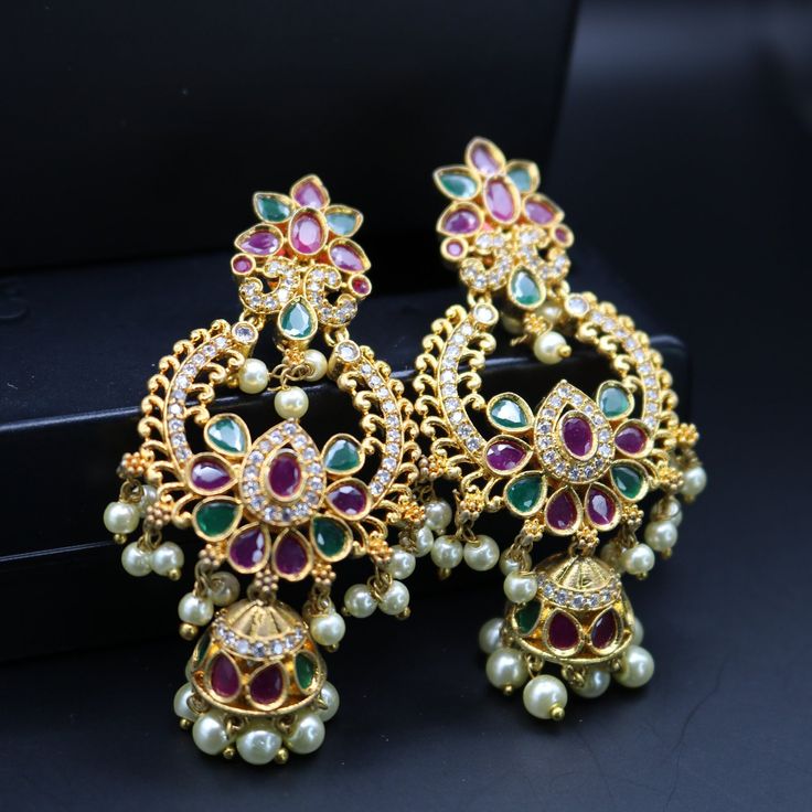 "Exquisite Chandbali earrings handcrafted in brass, adorned with sparkling CZ or shimmering pearls. Timeless elegance for any celebration, from birthdays and anniversaries to festival nights.\" Features: sparkling CZ or shimmering pearls Lightweight and elegant Can be paired with any dress, kurti, or saree Material: Brass Ready to ship from California Free US standard shipping Ready to ship CARE INSTRUCTIONS: 1) Please keep your Jewelry away from moisture and We advise you to do the following things to keep them lasts longer: 2) Please do not wear the jewelry at the time of workout to avoid accidental damage, while using hairspray and perfume. 3) Keep your jewelry away from chemicals. 4) Store jewelries separately, Different kinds of metal react together. To avoid this, store the jewelry i Dress Kurti, Saree Material, Fashion Collection Inspiration, Chandbali Earrings, Pearl Drop, Fashion Collection, Bridal Jewelry, Timeless Elegance, Care Instructions