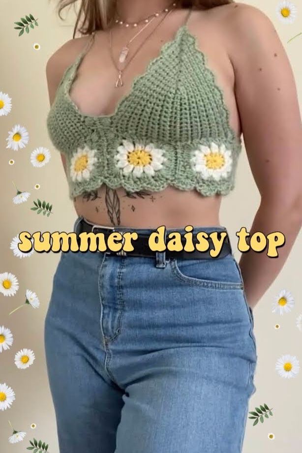 a woman wearing jeans and a crop top with flowers on the bottom is standing in front of daisies