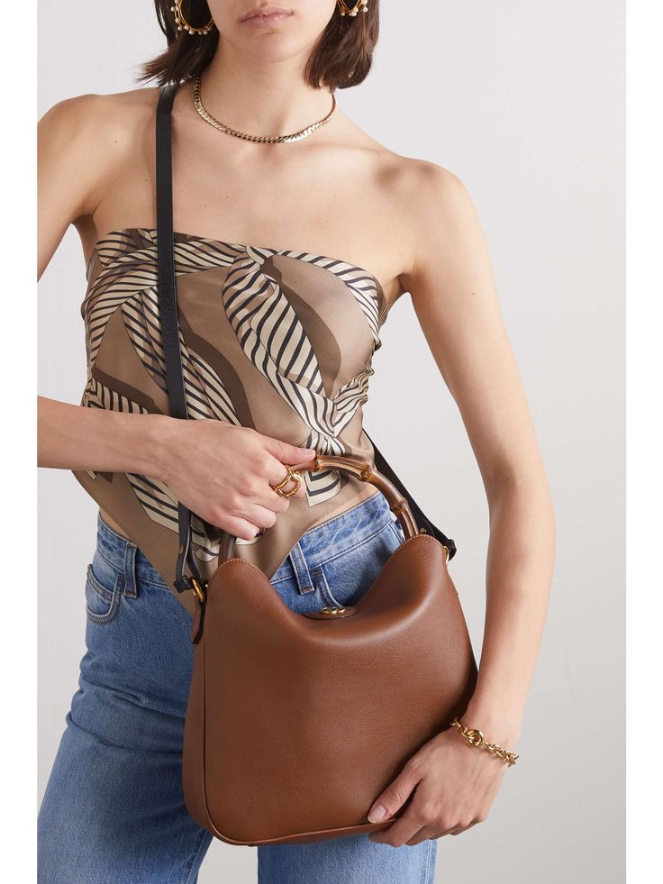 Chic Gucci Bag With Removable Pouch, Gucci Bucket Bag With Adjustable Strap, Designer Gucci Bucket Bag For Evening, Gucci Brown Soft Leather Shoulder Bag, Gucci Soft Leather Brown Shoulder Bag, Gucci Luxury Bucket Bag For Daily Use, Daily Use Gucci Luxury Bucket Bag, Brown Soft Leather Gucci Shoulder Bag, Daily Use Luxury Gucci Bucket Bag