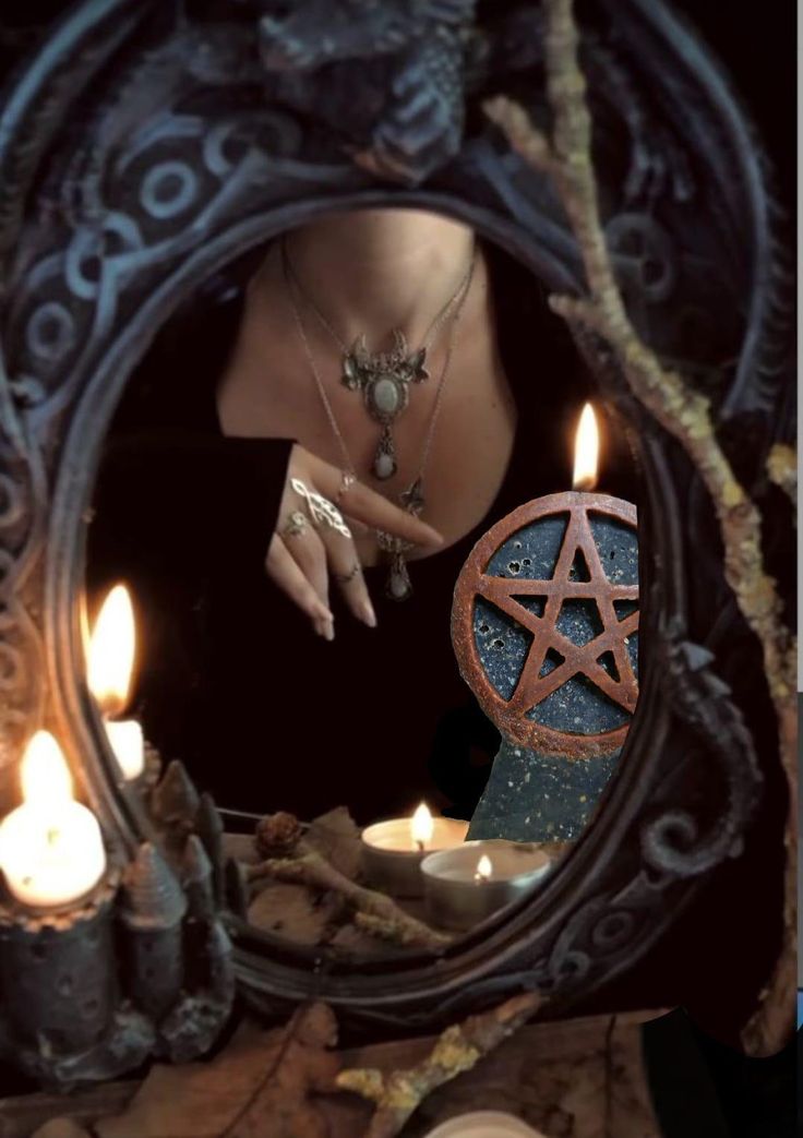 a woman looking into a mirror with candles in front of her and the image of a pentagramus on it