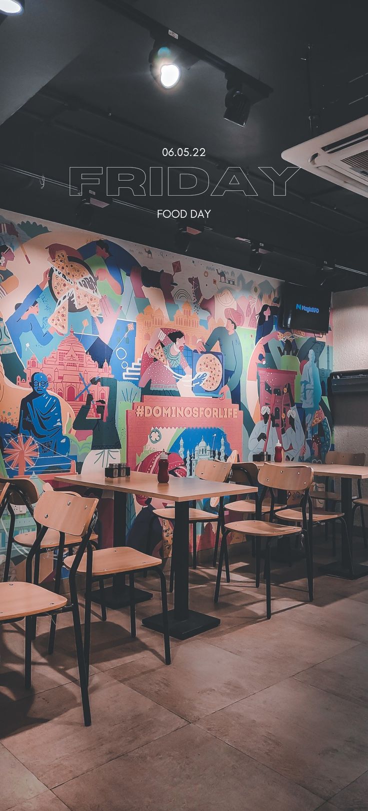 an empty restaurant with tables and chairs in front of a mural on the wall that reads, friday food day