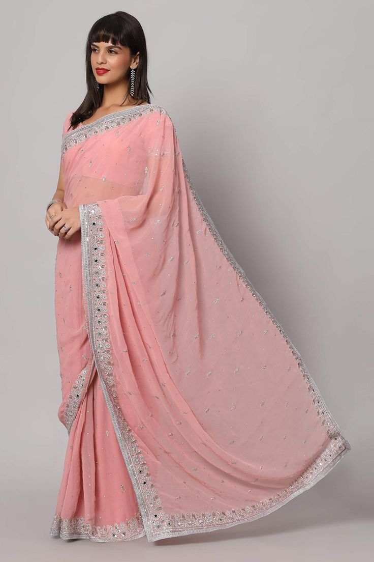 Isn't she pretty in pink in our Aaliya Dusty Rose Silver Embroidered Mirror Work One Minute Saree? This shining Pink Georgette saree isn't just a garment; it's a masterpiece. Each intricate stitch and shimmering mirror detail tell a story of craftsmanship and creativity. With a blouse crafted from the same ethereal fabric, featuring half sleeves and a graceful v-neck, it's a symphony of style. About this Product Saree: Saree Type: Ready to wear, Pre-stitched, Pre-draped Saree Saree Color: Pink S Pink Dola Silk Saree For Reception, Festive Pink Pre-draped Saree With Resham Embroidery, Pink Pre-draped Saree With Resham Embroidery In Chinon, Designer Pink Pre-draped Chinon Saree, Pink Bollywood Pre-draped Saree With Resham Embroidery, Designer Wear Pink Chinon Pre-draped Saree, Bollywood Style Pink Embroidered Pre-draped Saree, Bollywood Style Embroidered Pink Pre-draped Saree, Pink Chinon Pre-draped Saree For Designer Wear