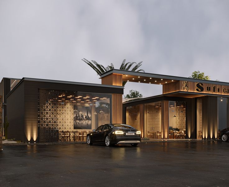 two cars parked in front of a building with lights on it's sides and an awning over the entrance