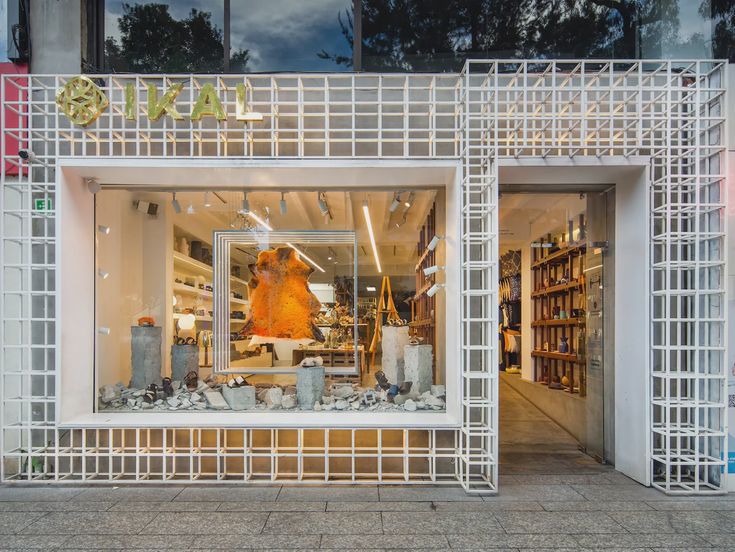 a store front with an open window on the outside and white latticed walls surrounding it