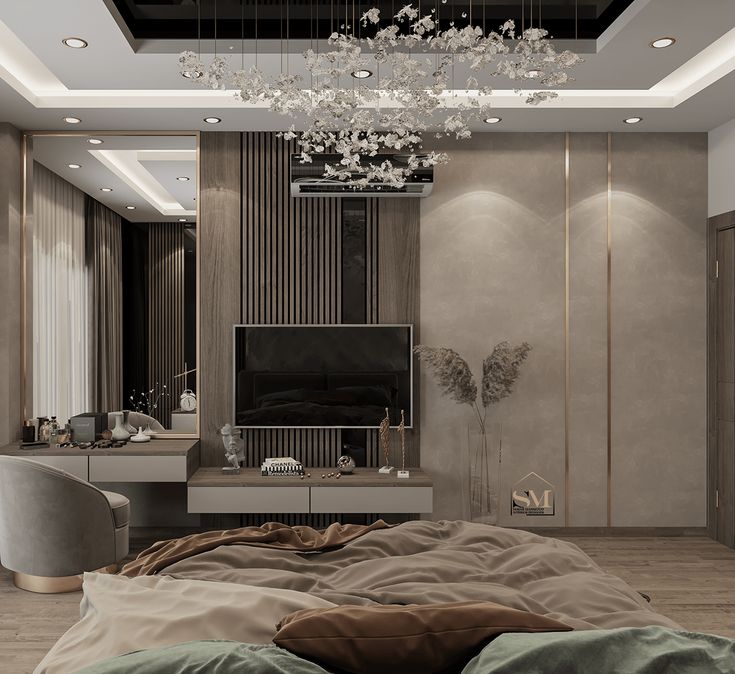 a large bed sitting under a chandelier next to a tv mounted on a wall