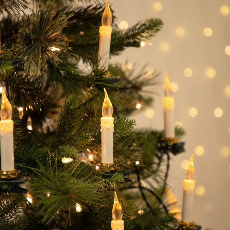 a christmas tree with lit candles on it