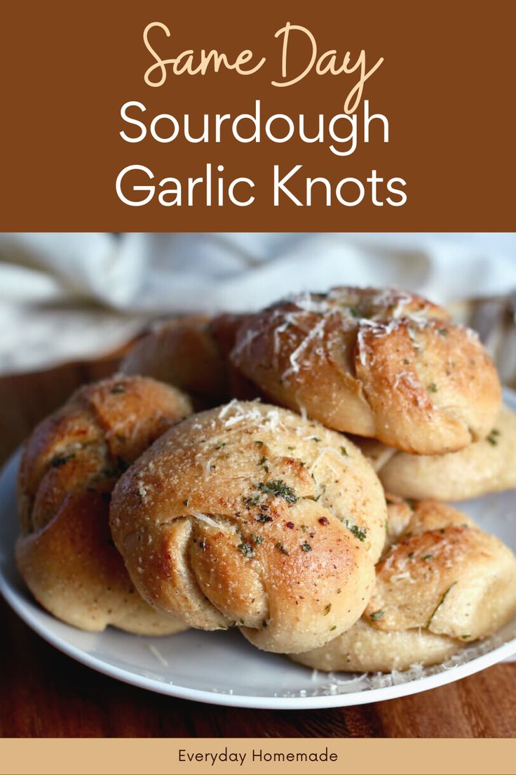 some very tasty looking bread rolls on a plate with the words same day sourdough garlic knots